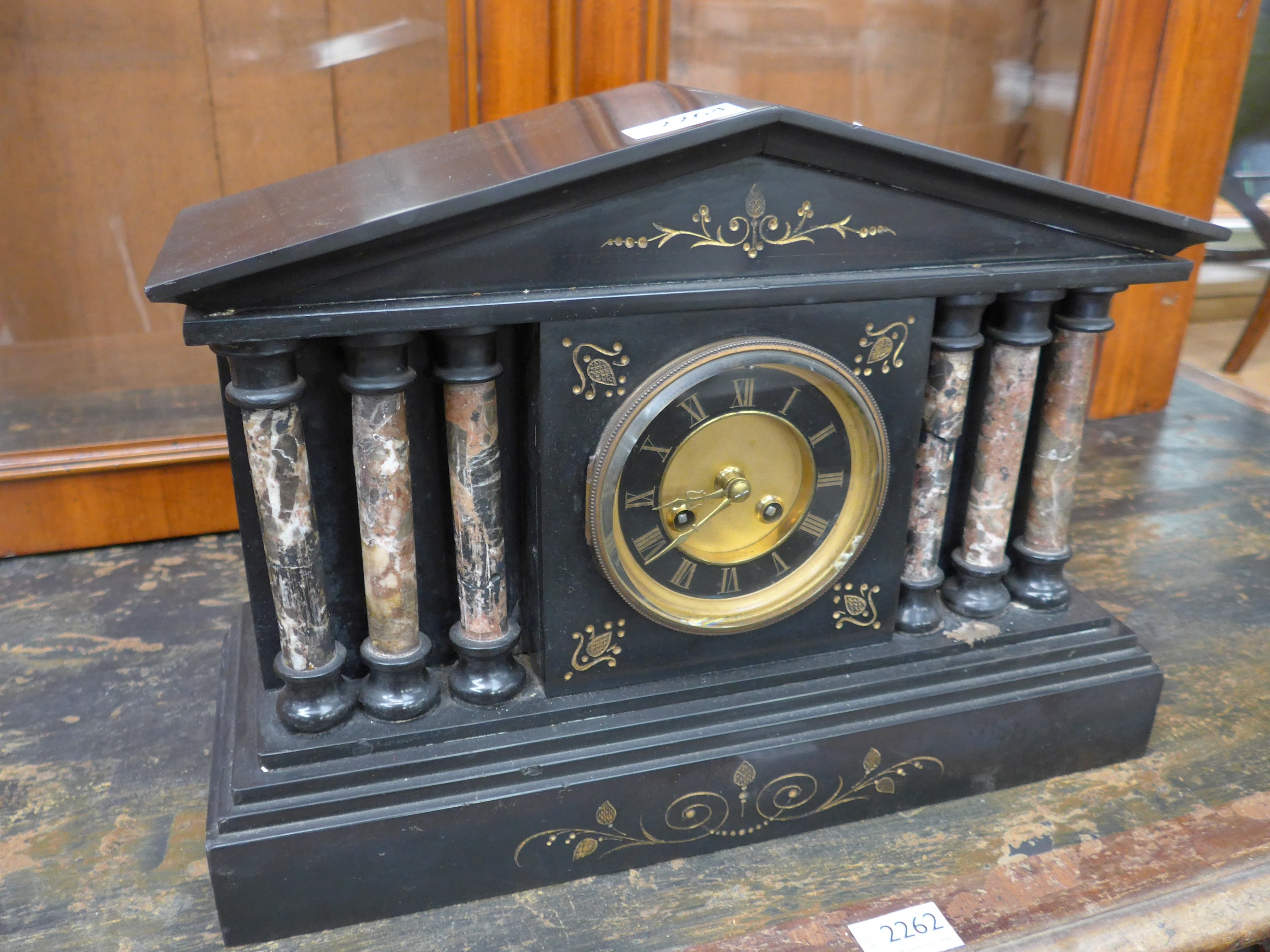 A Victorian black slate and marble mantel clock