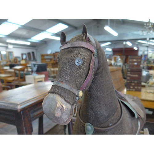 2001 - An early 20th Century painted pine rocking horse on bow rocker, can unscrew to be used on wheels