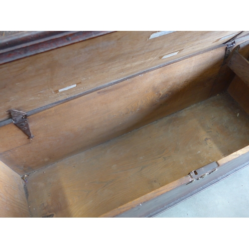 2003 - An 18th Century elm six-plank coffer, with hinged top above plain front panel, raised on bracket fee... 