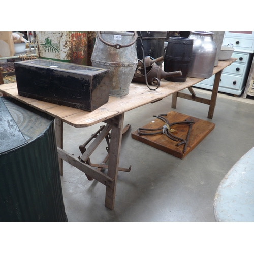 2048 - A large pine plank trestle table, 262x76cm