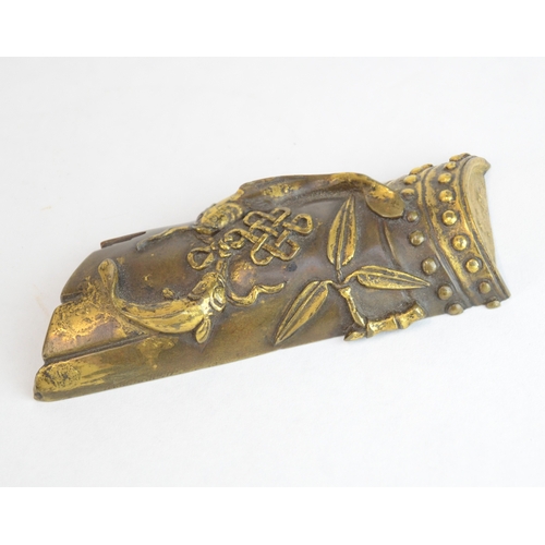 7006 - A Chinese bronze scroll weight decorated with two Buddhist symbols, the endless knot, two golden fis... 