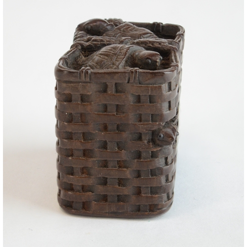 A wood netsuke in the form of a wicker basket of turtles, signed ...