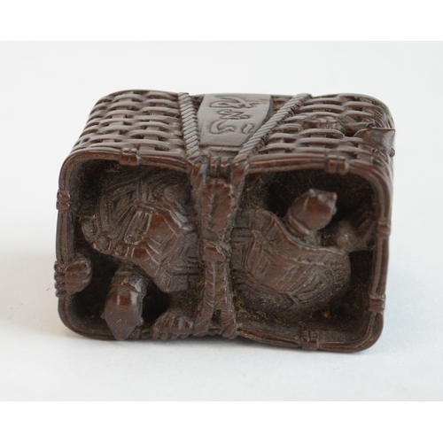A wood netsuke in the form of a wicker basket of turtles, signed ...