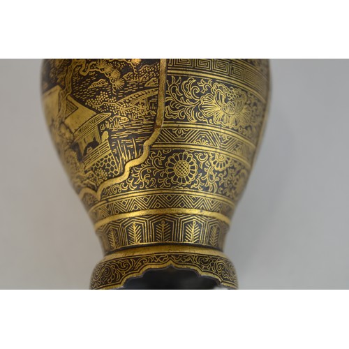 7004 - A miniature Japanese shakudo and gold metal vase, signed

 7cm high x 4.5cm at widest point

 Proven... 