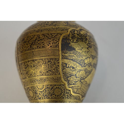 7004 - A miniature Japanese shakudo and gold metal vase, signed

 7cm high x 4.5cm at widest point

 Proven... 