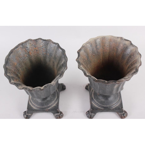 125 - A pair of cast metal campana urns with flared rims, on square base with paw supports, 6 1/2