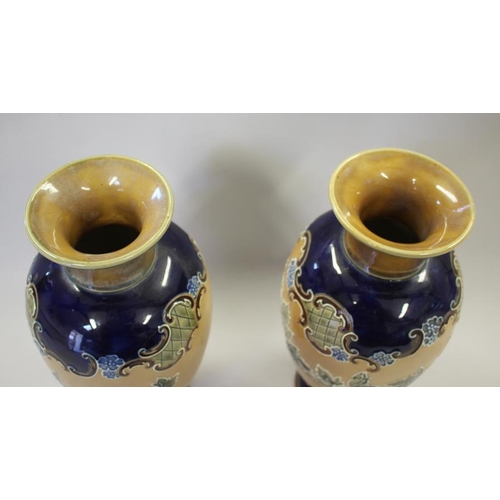 3 - A pair of Royal Doulton tube-lined ware vases with floral decoration, 12