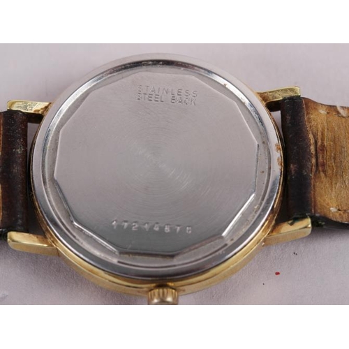 386 - A gentleman's Longines Conquest wristwatch with gold dial and baton numerals, on brown leather strap