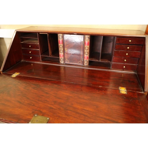 498 - A Georgian mahogany fall front bureau with interior fitted pigeonholes and central cupboard over fou... 