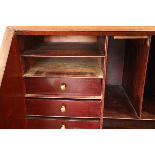 498 - A Georgian mahogany fall front bureau with interior fitted pigeonholes and central cupboard over fou... 