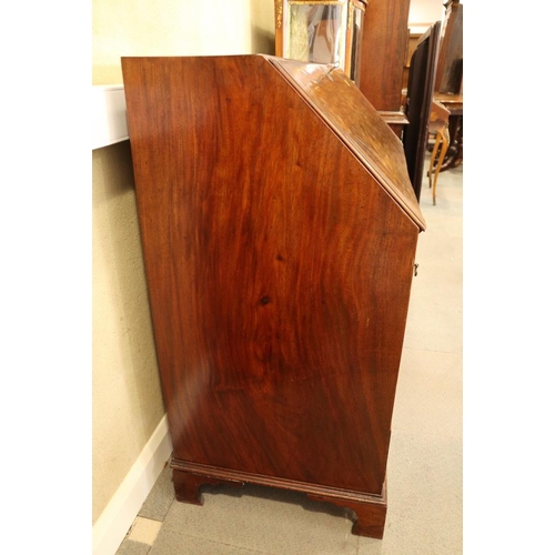 498 - A Georgian mahogany fall front bureau with interior fitted pigeonholes and central cupboard over fou... 