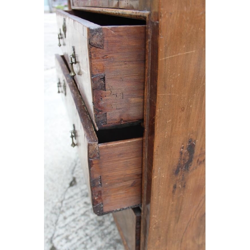 517 - A George III walnut and banded chest of four graduated long drawers with brass drop handles, on turn... 