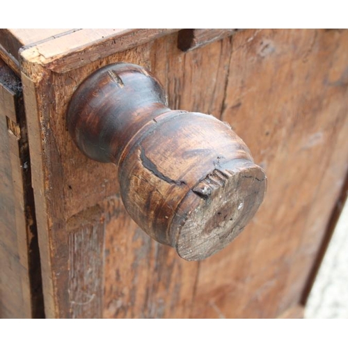 517 - A George III walnut and banded chest of four graduated long drawers with brass drop handles, on turn... 