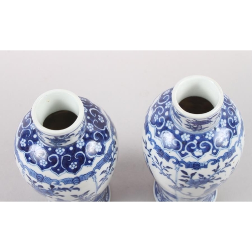 53 - A pair of 19th century Chinese blue and white vases, decorated panels with figures, birds and flora ... 