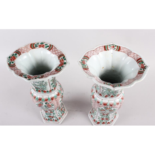 55 - A pair of Chinese 18th century design gu vases, decorated floral reserves, 12 1/4