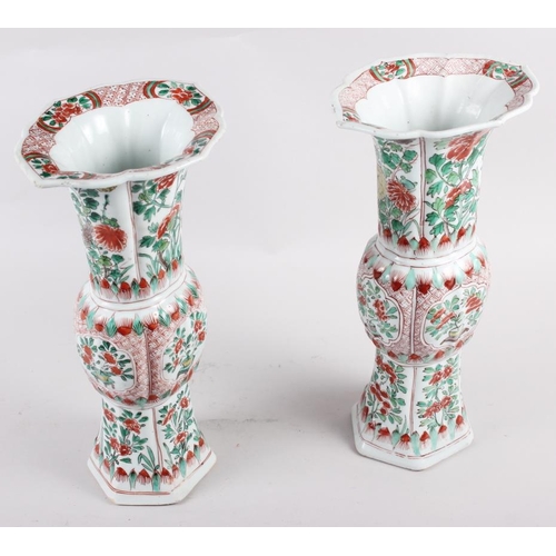 55 - A pair of Chinese 18th century design gu vases, decorated floral reserves, 12 1/4