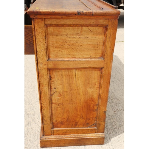 566 - An antique oak, ash, elm and chestnut dresser base, fitted three drawers with brass handle plates ov... 