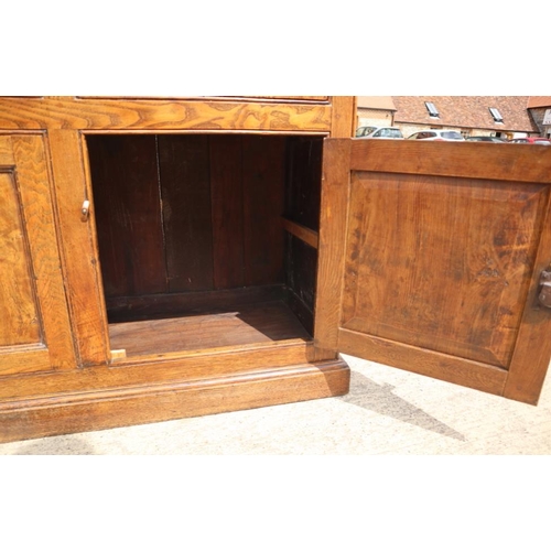 566 - An antique oak, ash, elm and chestnut dresser base, fitted three drawers with brass handle plates ov... 