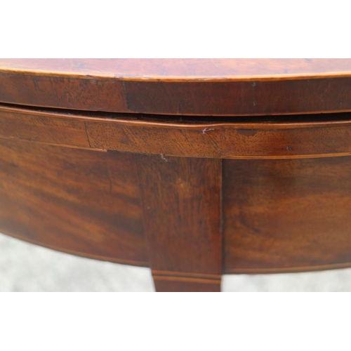 567 - A 19th century semicircular mahogany fold-over top card table, on square taper supports, 36