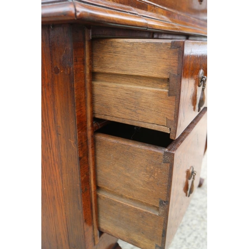 569 - An early 18th century burr walnut chest on stand, the upper section with two short and three long gr... 