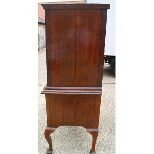 569 - An early 18th century burr walnut chest on stand, the upper section with two short and three long gr... 