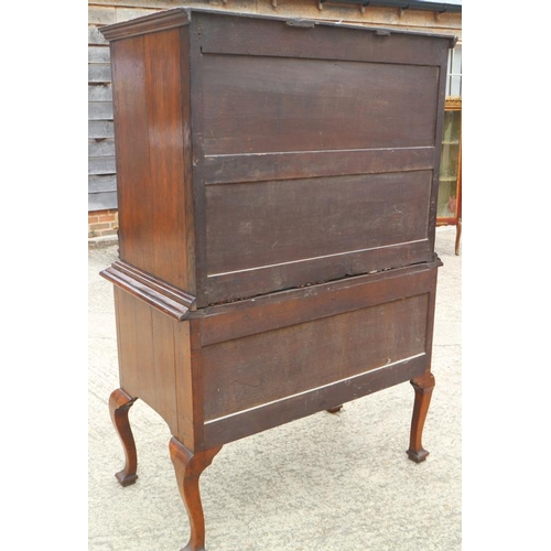 569 - An early 18th century burr walnut chest on stand, the upper section with two short and three long gr... 