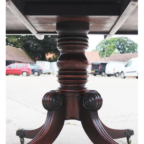 571 - A Georgian Cuban mahogany rectangular dining table, on turned column and quadruple splay supports wi... 