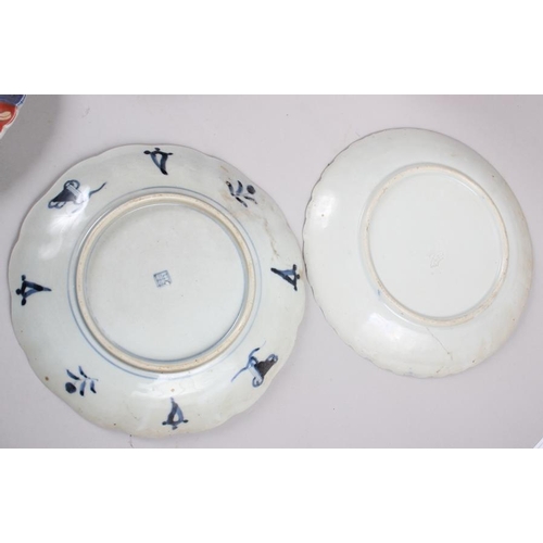 60 - Six Imari plates of various designs, and a similar pair of vases (one with cover missing)