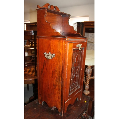 604 - A walnut coal purdonium with raised  back, carved central panel and carrying handles, on stile suppo... 