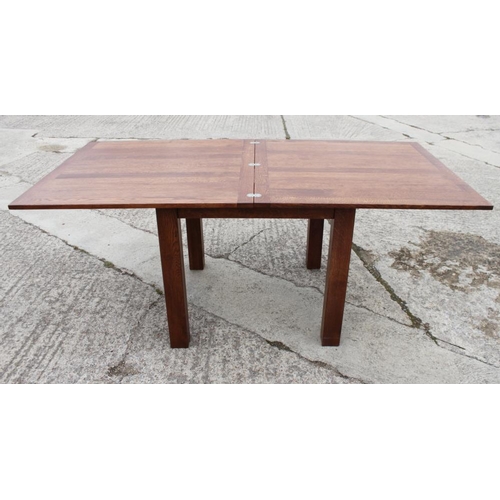 628 - An oak fold-over top dining table, on square supports, 71