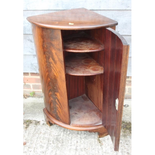 631 - A mahogany bowfront corner cupboard, on bracket feet, 22