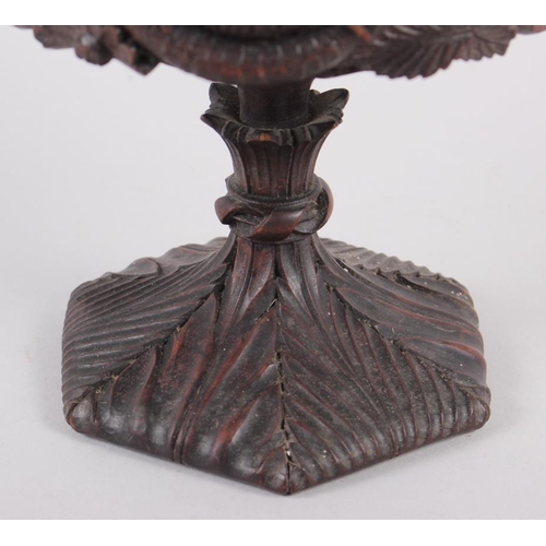 150 - A carved softwood urn and cover with acanthus decoration and goat's head handles, 12