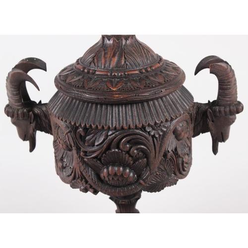 150 - A carved softwood urn and cover with acanthus decoration and goat's head handles, 12