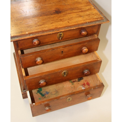 153 - A walnut miniature chest of four long graduated drawers with brass mounted locks (one missing), on b... 