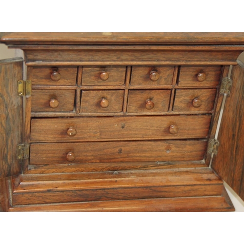 155 - A collectors mid 19th century rosewood cabinet of eight small drawers and two long drawers enclosed ... 