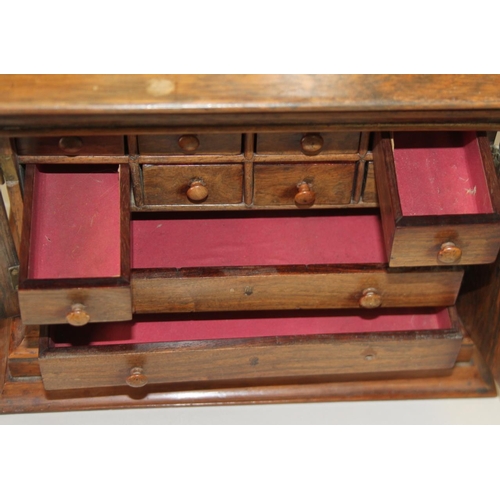 155 - A collectors mid 19th century rosewood cabinet of eight small drawers and two long drawers enclosed ... 