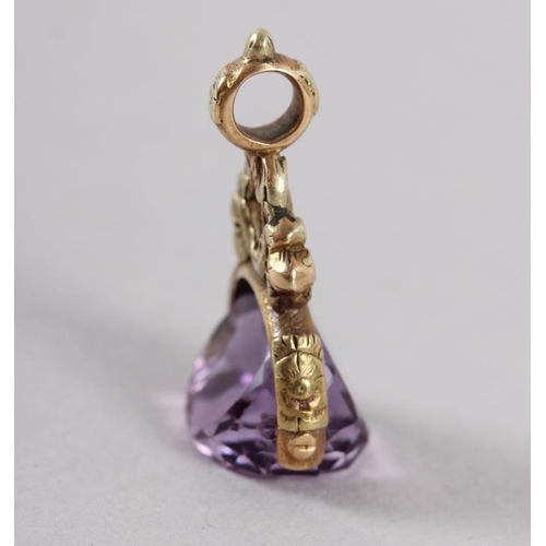 375 - A 19th century yellow metal and amethyst fob spinner with floral decoration