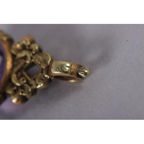 375 - A 19th century yellow metal and amethyst fob spinner with floral decoration