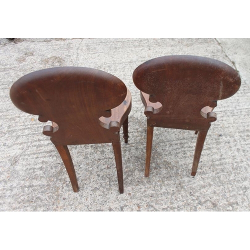 527 - A pair of George III carved mahogany hall chairs with shell backs and panel seats, on turned support... 