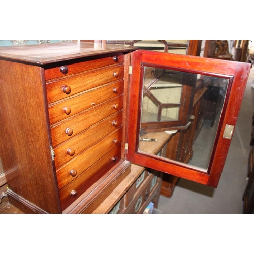 558 - A mahogany collectors cabinet, fitted seven long graduated drawers enclosed glass door on plinth bas... 