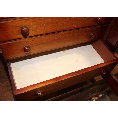 558 - A mahogany collectors cabinet, fitted seven long graduated drawers enclosed glass door on plinth bas... 