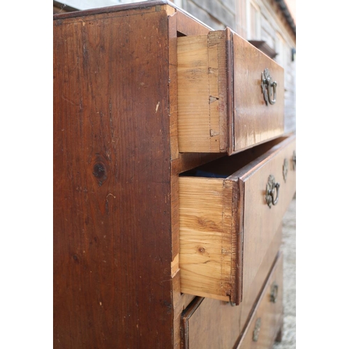 560 - A late Georgian walnut and banded chest of two short and three long drawers with brass handles, on b... 