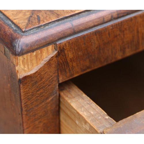 560 - A late Georgian walnut and banded chest of two short and three long drawers with brass handles, on b... 