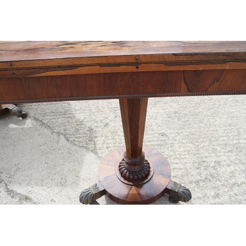 561 - A pair of Regency rosewood fold-over top card tables, on faceted inverse taper columns and circular ... 