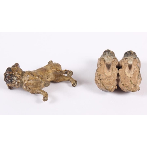 110 - An Austrian miniature cold painted bronze model of a standing pug and a similar pair of seated pugs