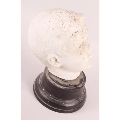 244 - A white marble bust of a young man, on ebonised base, 7 3/4