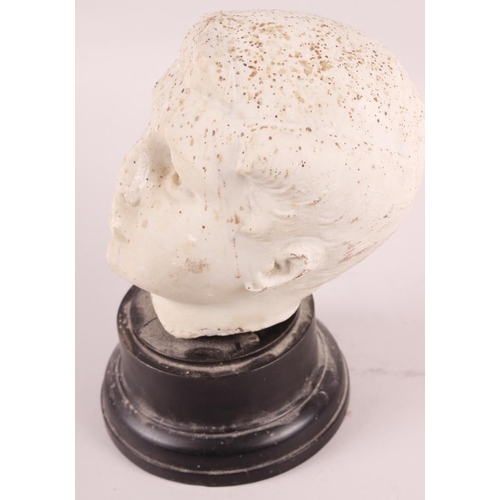 244 - A white marble bust of a young man, on ebonised base, 7 3/4