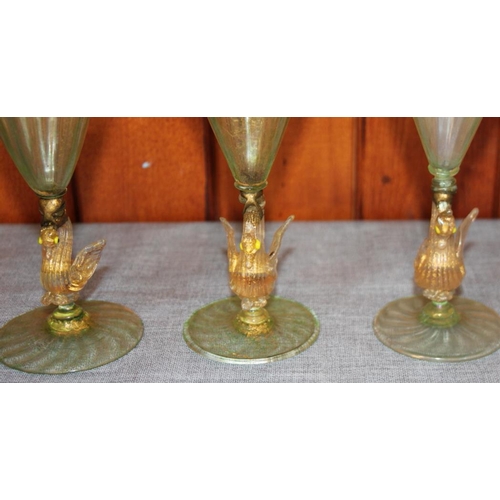 217 - Three similar Venetian green pedestal glasses with stems formed as swans, four brushes, a playing ca... 