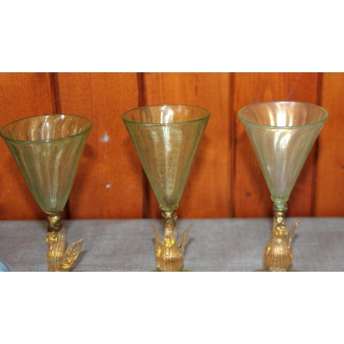 217 - Three similar Venetian green pedestal glasses with stems formed as swans, four brushes, a playing ca... 