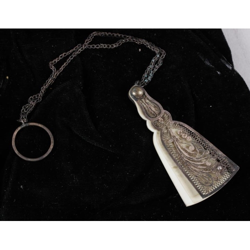 313 - A white metal filigree fan-shaped aide-memoir and a silver mounted evening purse